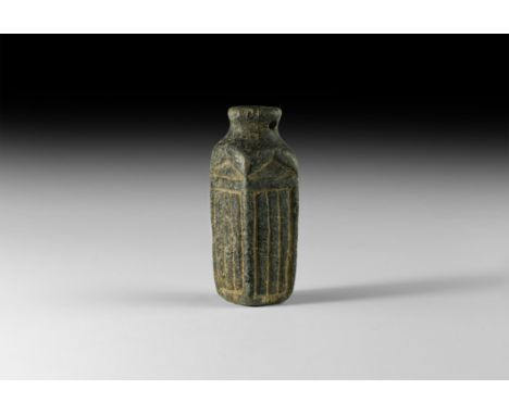 1st millennium BC. A square-section serpentine cosmetic bottle with everted rim, segmented panel to each face.   55.8 grams, 