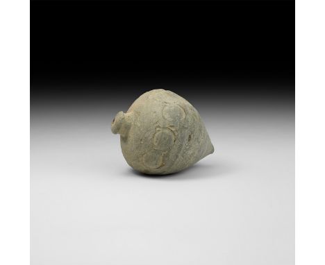 9th-11th century AD. A hollow ceramic piriform vessel with conical top and thick rim, shoulder decorated with a band of round