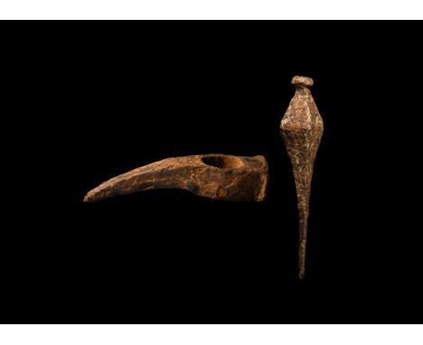 1st-2nd century AD. A group of iron tools comprising a curved pick with hammer to the reverse, and a spike with knop finial. 