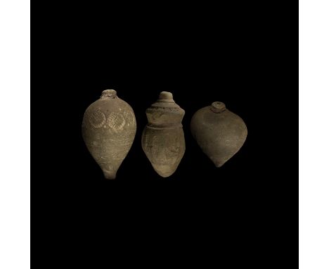 9th-11th century AD. A group of three hollow ceramic vessels each with conical body, intended to be filled with explosive liq