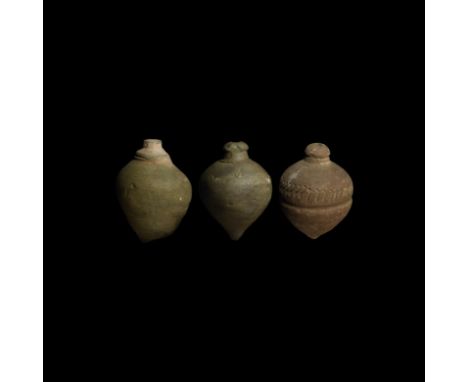 9th-11th century AD. A group of three hollow ceramic vessels each with conical body, intended to be filled with explosive liq