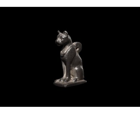 Saite Period, 624-525 BC. A silver pendant depicting a sitting cat, Bastet, the goddess of the home, domesticity, women's sec