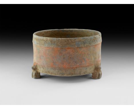 Han Dynasty, 206 BC-220 AD. A squat ceramic jar with circumferential bands, three radiating animal figures forming the feet. 