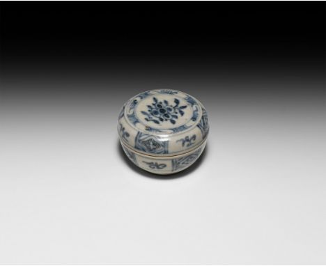 Ming Dynasty, 15th-16th century AD. A ceramic blue and white lidded powder box, painted with scrolled tendrils and diamond-sh