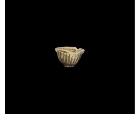 Ptolemaic Period, 332-30 BC. A cream ceramic miniature vessel with ribbed body and pierced lug handles.   4.5 grams, 28mm (1"