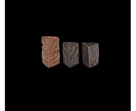 23rd-20th century BC. A mixed group of three bronze seals, all with triangular cross-section and design to three sides, pierc