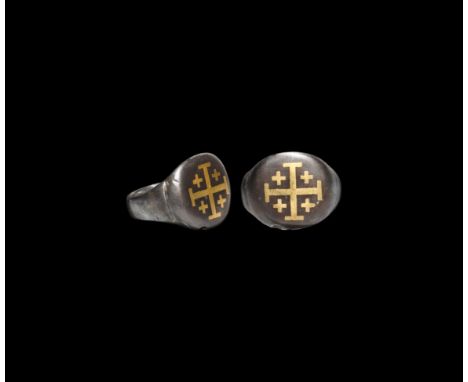 11th-13th century AD. A substantial silver ring with flat-section hoop, large discoid bezel with inlaid gold cross potent sur