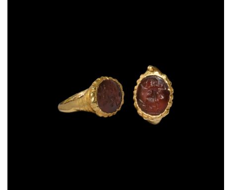 2nd-3rd century AD. A hollow-formed gold ring with applied granule to shoulder, discoid bezel with scalloped edge, inset with