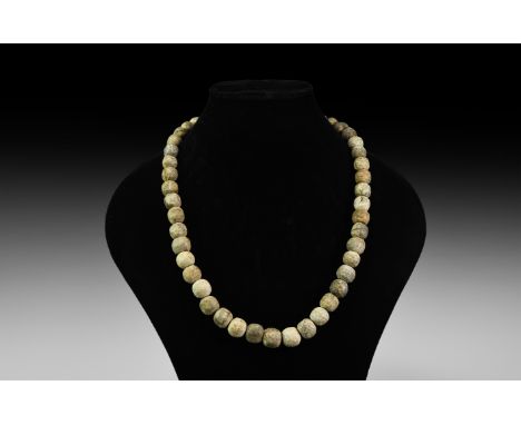 Devensian Period, 110,000-12,000 years BP. A restrung group of oblate mammoth bone beads.   167 grams, 64cm (25 1/4"). From t