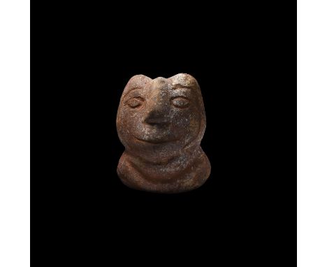 4th century BC. A rhyolite idol with bulbous head and body, low-relief facial features, arms forming a horizontal band across