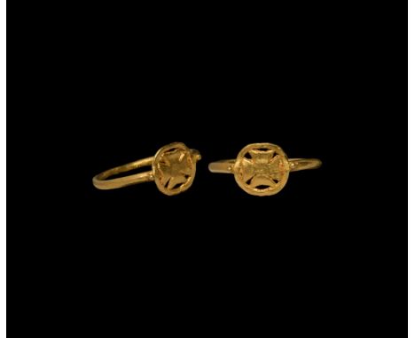 6th-7th century AD. A slender gold ring with disc bezel, openwork Maltese cross motif.   2.32 grams, 19.10mm overall, 15.76mm