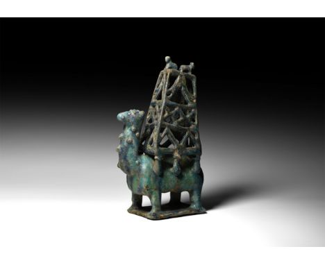 20th century AD or earlier. A ceramic turquoise glazed Bactrian camel on rectangular base with lattice tower upon back, surmo