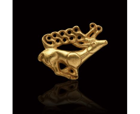 7th-6th century BC. An exceptional gold ornament representing a galloping stag, legs folded under the body, the erect head is