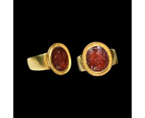 1st-2nd century AD. An ellipsoid carnelian cloison with intaglio profile of the goddess Roma sitting with crested helmet, shi