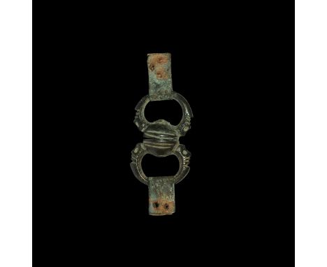 11th-12th century AD. A swivel with two rings, each loop formed as a pair of opposed zoomorphic heads clutching the swivel-ha