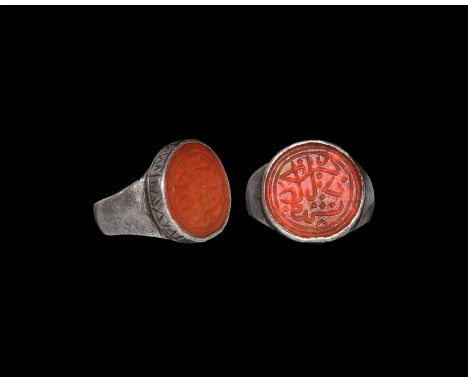 14th century AD. A silver finger ring comprising a convex hoop, drum-shaped bezel with hatching to the cell, inset carnelian 