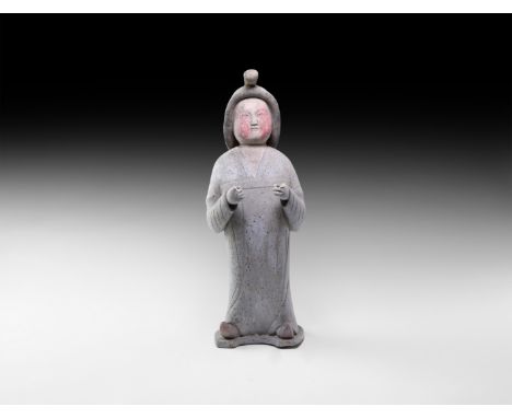 Tang Dynasty, 618-906 AD. A hollow-formed ceramic figure in floor-length robe with separately modelled hair, pigment to the s