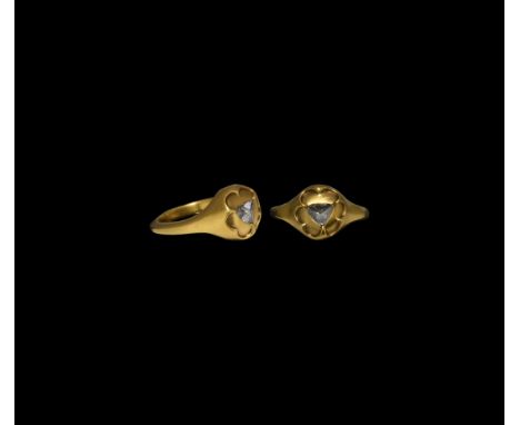 15th-16th century AD. A gold ring comprising a D-section hoop with heart-shaped panel to the underside, round bezel with hexa