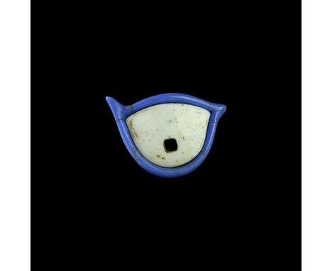 New Kingdom, 1550-1070 BC. An eye from a mummy mask or sarcophagus comprising a blue glass frame, white glass sclera with squ