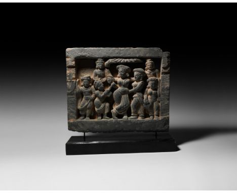 2nd-3rd century AD. A grey schist panel with high-relief image of Queen Maya standing with attendants beneath a canopy, the i