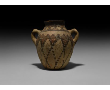 2nd century BC-2nd century AD. A ceramic jar with slightly flared rim and loop handles to the shoulders, bands of geometric p