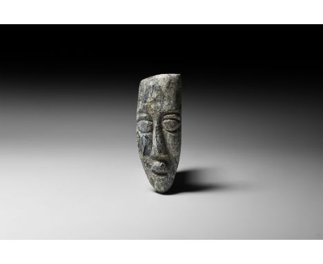 Pliocene Period, 5.2-2.5 million years BP. A mastodon fossil tusk with later carving depicting a stylised face.   57 grams, 1