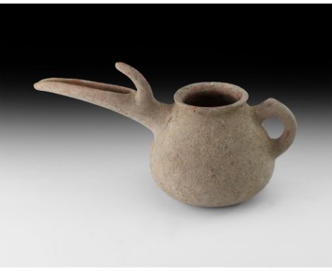 3rd-2nd millennium BC. A squat ceramic jar with rolled rim, loop handle, scooped U-section spout with spur to the rear.   721