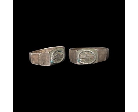 2nd-3rd century AD. A silver ring comprising a flat-section facetted hoop with beaded collar to the bezel, inset panel with c