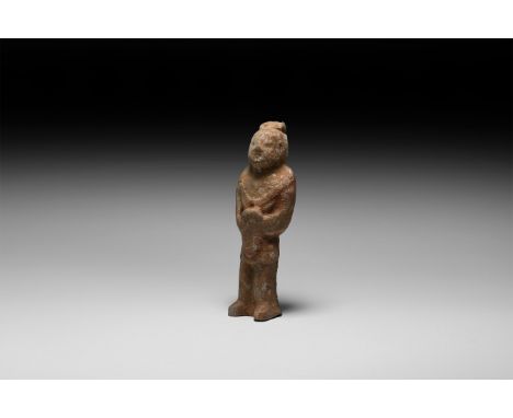 Zhou Dynasty, 1046-256 BC. A ceramic figure of a standing soldier from the Zhou period, on an integral base; surviving pigmen