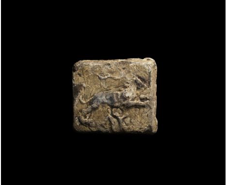 1st-3rd century AD. A square tabular lead weight with an image of a leaping lion with symbols on the field.   265 grams, 51mm
