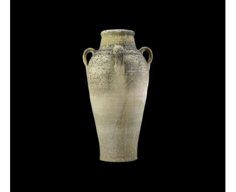 Tang Dynasty, 618-906 AD. A large ceramic amphora with tapering body, rounded shoulder with concentric lines, four strap hand