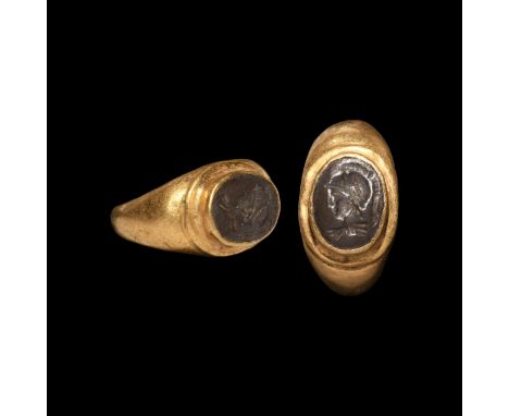 3rd century AD. A substantial gold finger ring with stepped bezel, cell with inset silver plaque, intaglio bust of Mars with 