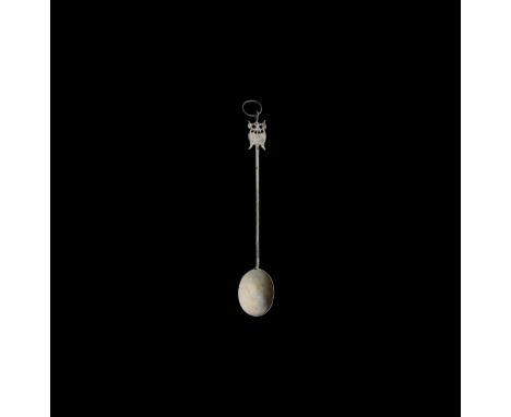8th-9th century AD. A silver spoon with deep bowl, square-section handle with hatched panels, two addorsed birds to the finia