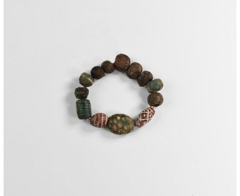 1st-3rd century AD and later. A restrung group of mosaic glass beads including a tabular millefiori bead; lamp- and furnace w