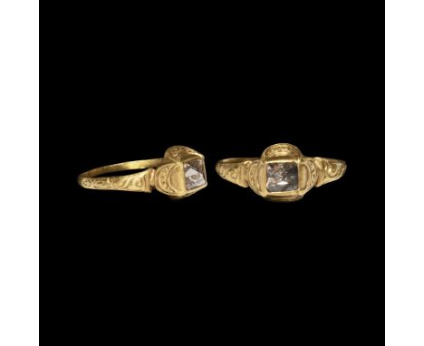 16th century AD. A delicate gold ring with thin band expanding to engraved shoulders supporting a square cell bezel with cres