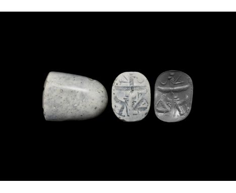 2nd millennium BC. A carved quartz stamp seal with intaglio scene of a Faravahar solar disc above a crouching sherdal winged 