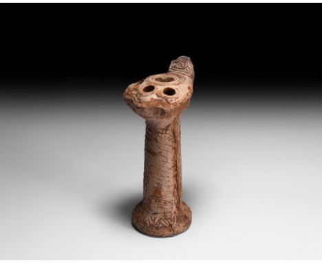 6th-8th century AD. A terracotta lamp with tall tubular pillar, lion's claw lamp with nozzle to each claw and central discuss