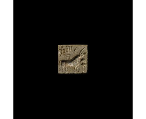 26th-19th century BC. A square ceramic stamp seal with ribbed suspension loop to the reverse; engraved with long-horned bull 