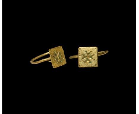 12th-14th century AD. A slender gold ring with square bezel, intaglio cross moline with pellet to each angle, green enamel in