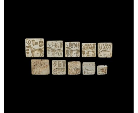 26th-19th century BC. A group of ten rectangular stone and ceramic stamp seals with suspension loops comprising: six with a l