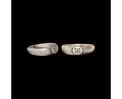 6th-8th century AD. A silver ring with expanding D-section hoop, raised oval intaglio engraved with a monogram.   4.85 grams,