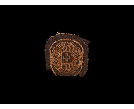 3rd-6th century AD. A decorative textile panel with embroidered border, band of segmented loops and central voided cross.   2