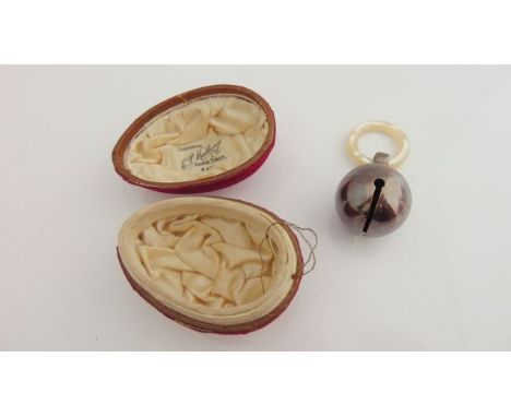 A silver baby's rattle, Deakin & Francis Ltd, Birmingham, probably 1921, of circular form with engine-turned band, mother-of-