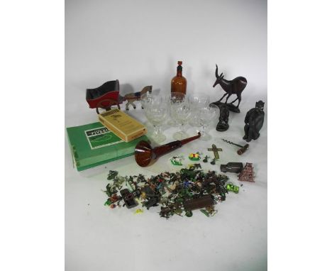 A collection of vintage drinking glasses together with carved timber models of monkeys and other animals, a brown glass bottl