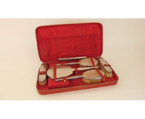 A cased travelling dressing set, Adie Brothers Ltd, Birmingham, 1938 & 1939, comprising: two hair brushes, a hand mirror, two