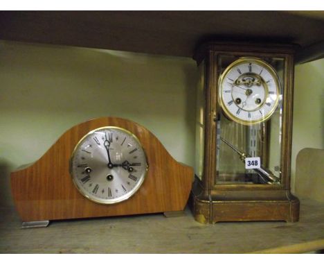 A mid 19th century brass cased four pane mantle clock with enamelled dial and visible escapement, mercury compensating pendul