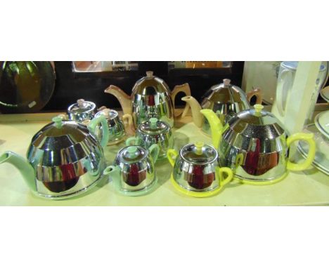 A collection of Art Deco type tea wares with pastel coloured ceramic bodies and chrome type overlay comprising two teapots, a