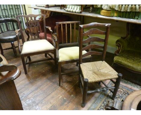 Two simple Georgian mahogany elbow chairs with drop in seats, together with a country made ladder back chair with rush seat