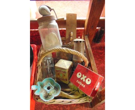 A wicker work basket containing vintage Union Jack flags, printed tins to include Rudman's Pea Green Petraline, Squirrel Conf