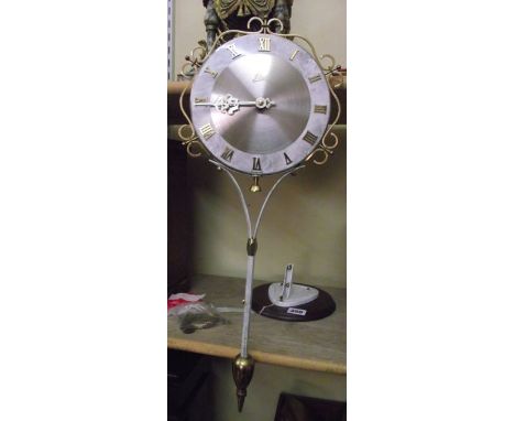 A retro German wall clock by Schatz with simulated marbled dial and brass framework, complete with bracket